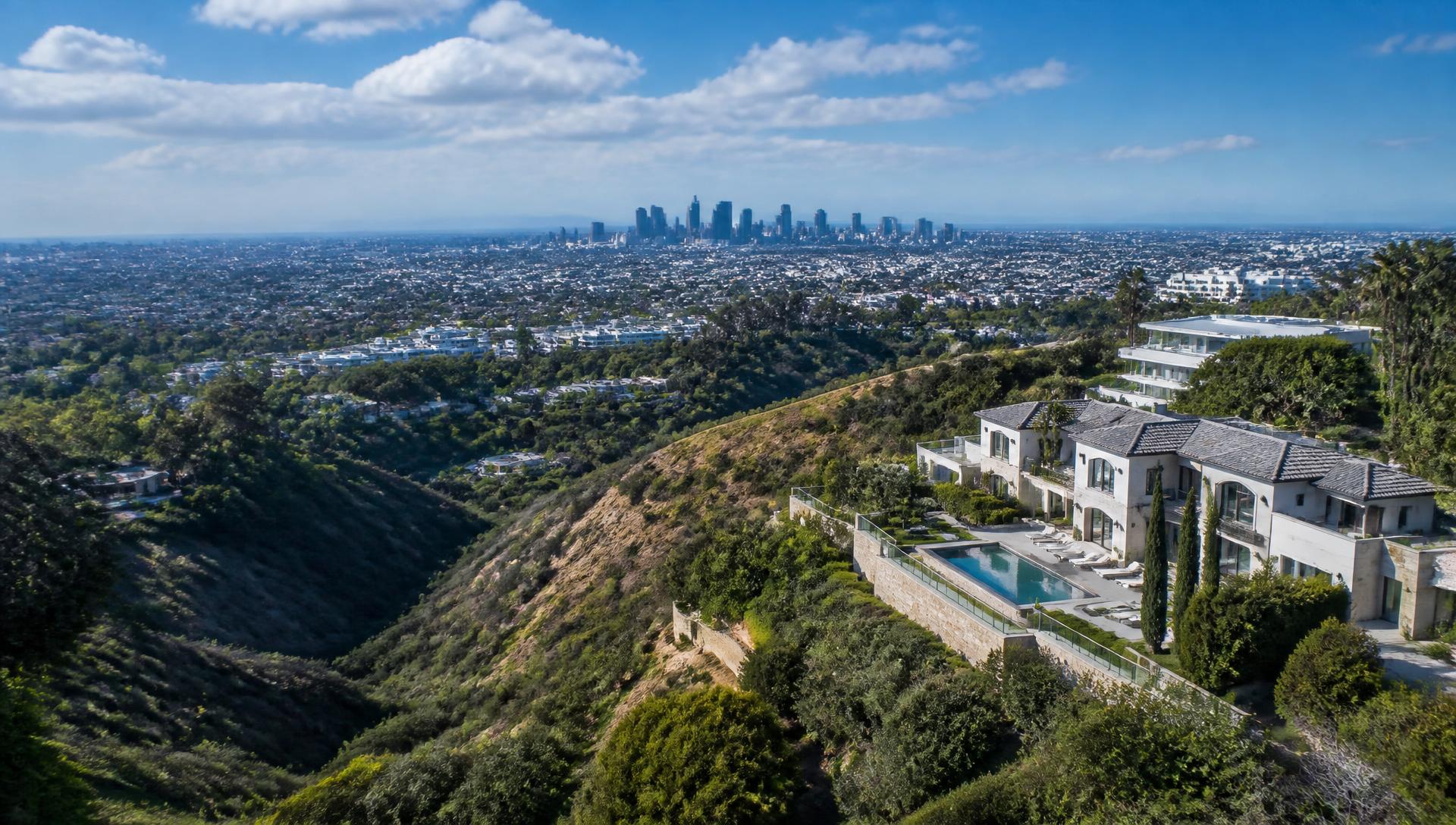Aerial view from Hollywood Hills overlooking Los Angeles with hillside estates and the downtown skyline